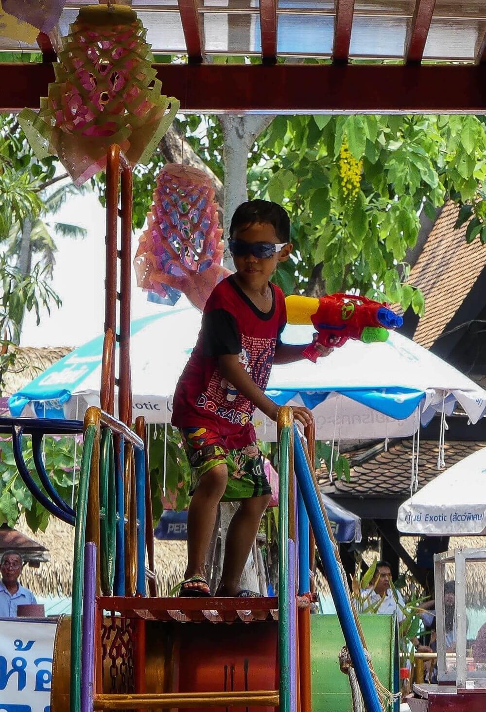 Happy Songkran Day | Young boy about to shoot water pistol