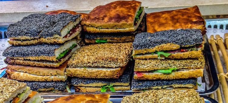 Gluten free in Paris| square focaccia sandwiches topped with poppy seeds and sesame seeds
