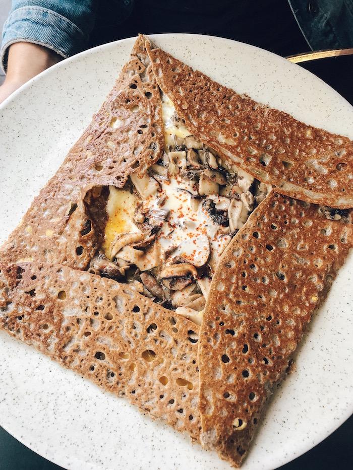 A savoury galette - brown crepe with the corners folded over. 