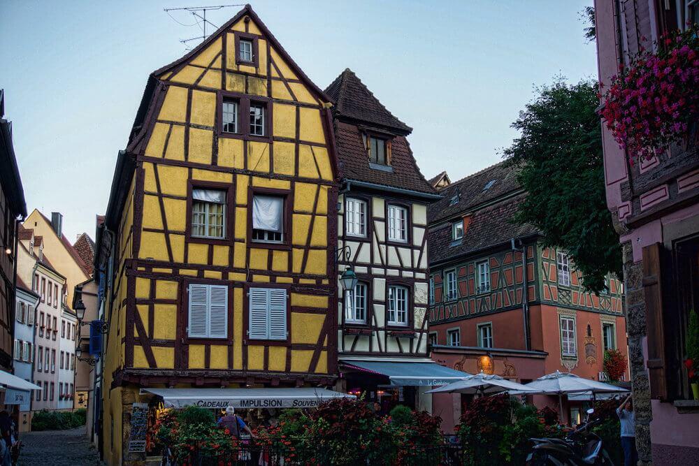 Visit Colmar: Tall yellow medieval home with wooden framing