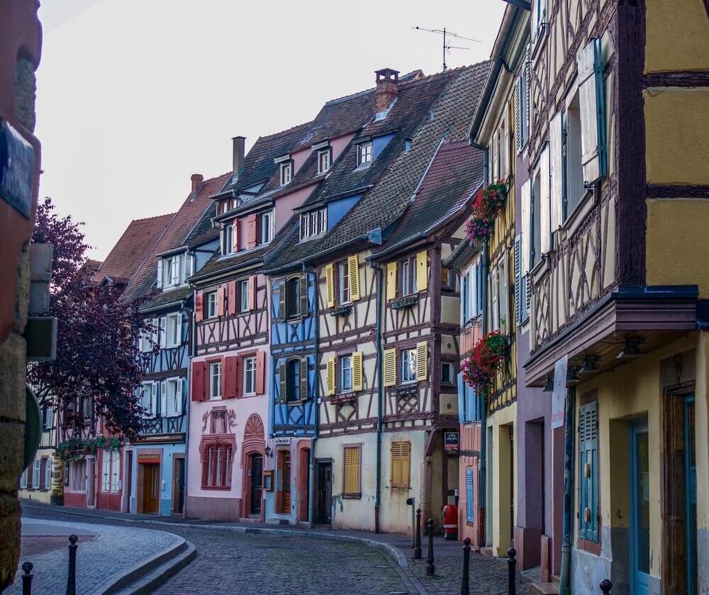 Visit Colmar: red, blue and yellow half-timbered medieval houses