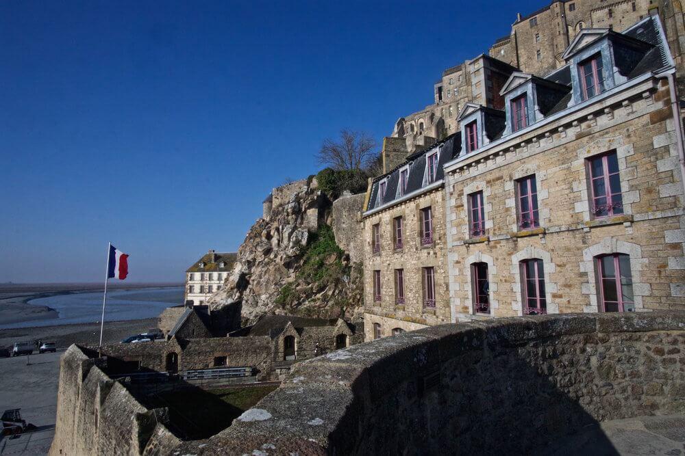 view of the French flag, old medieval town and the sea