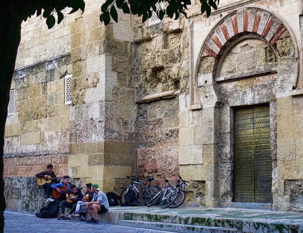 youngsters sitting outside the mezquita in Cordoba