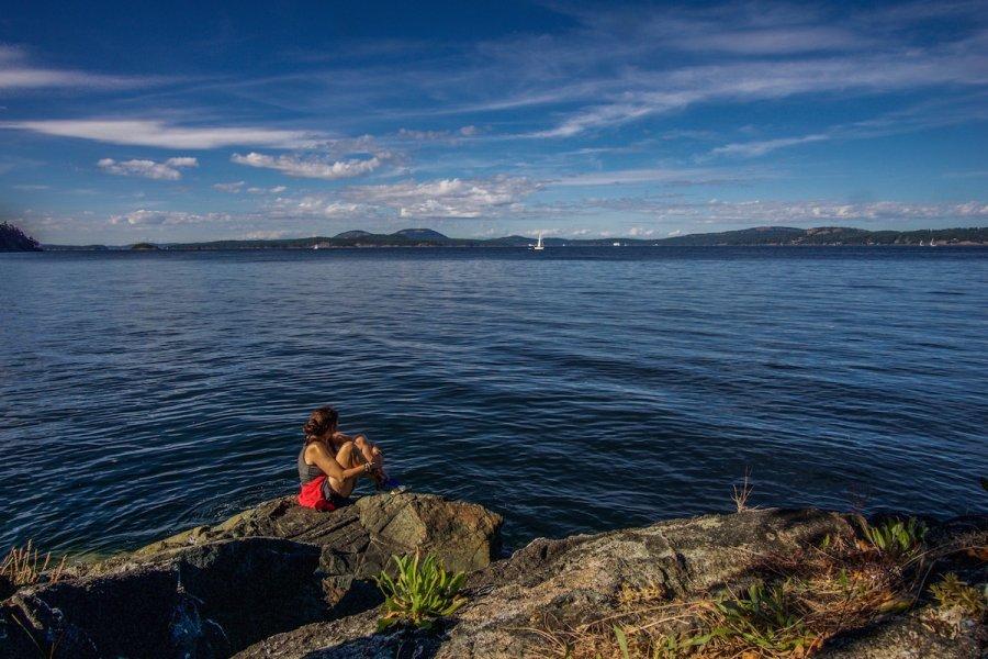 Travel Destinations: Sitting on the rock at Ruckle Provincial park, Saltspring Is, Canada. Ocean glistening