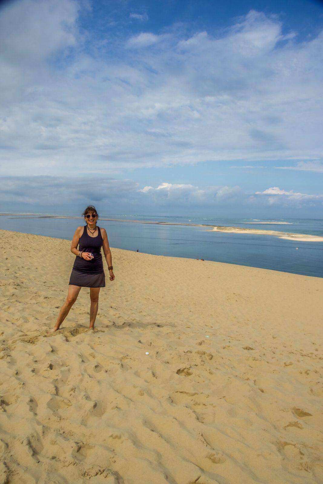 Alison Browne on the sand dune with the ocean behind