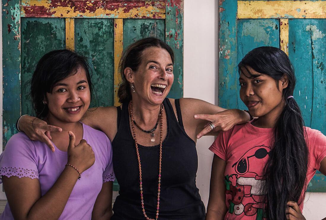 solo travel over 50: Lady inbetween 2 Balinese girls. All Smiling
