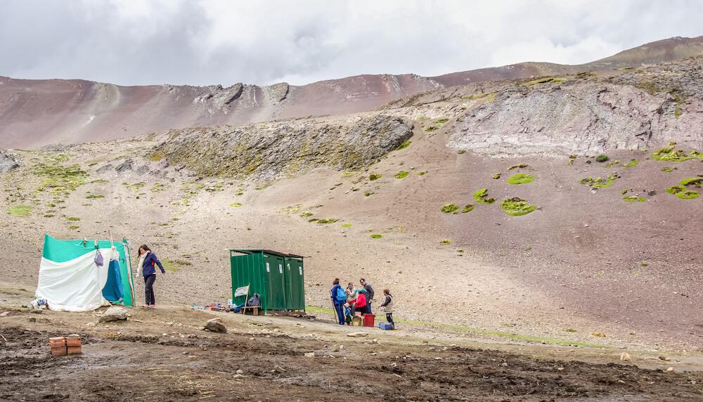 Lone traveller | people lined up for the outhouse on a barren mountain side