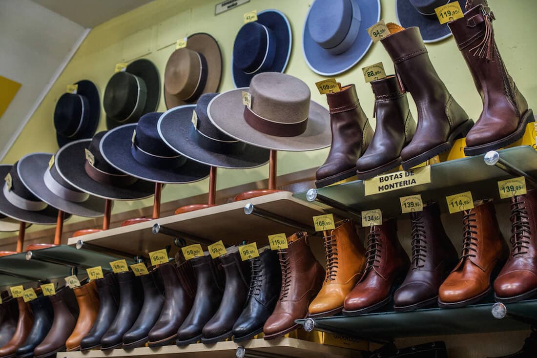 Rows of leather boots and Spanish men's hats