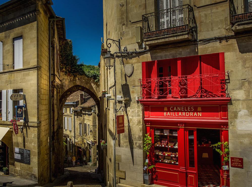 Saint-Émilion France: red store front and tiny cobblestone street