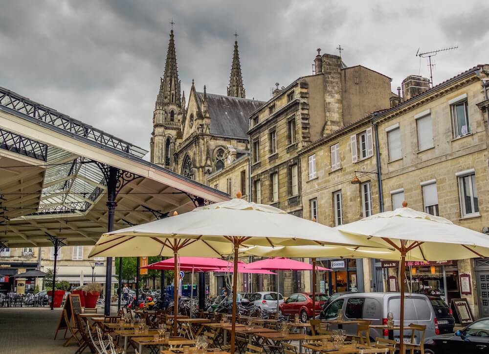 Visit Bordeaux -Cafe umbrellas and church spires in Chartrons