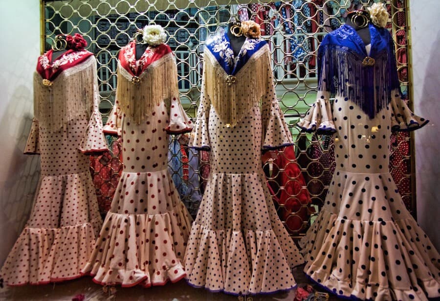 Polka dotted flamenco dresses for sale in a shop window.
