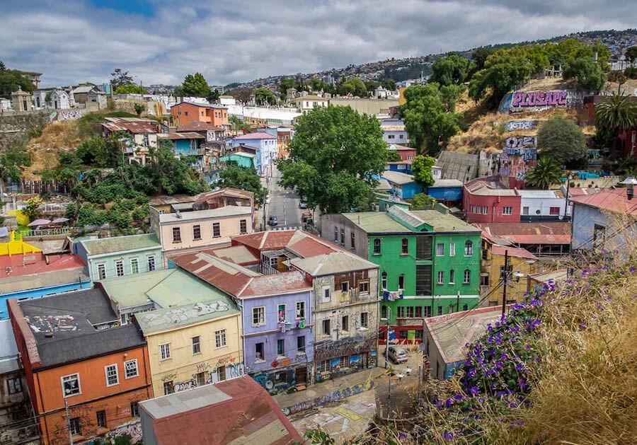 colourful houses dot the road and hillside 