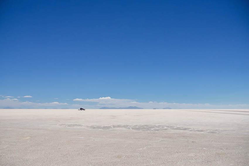 Salar de Uyuni Tour - vast white salt flats and a tiny looking jeep