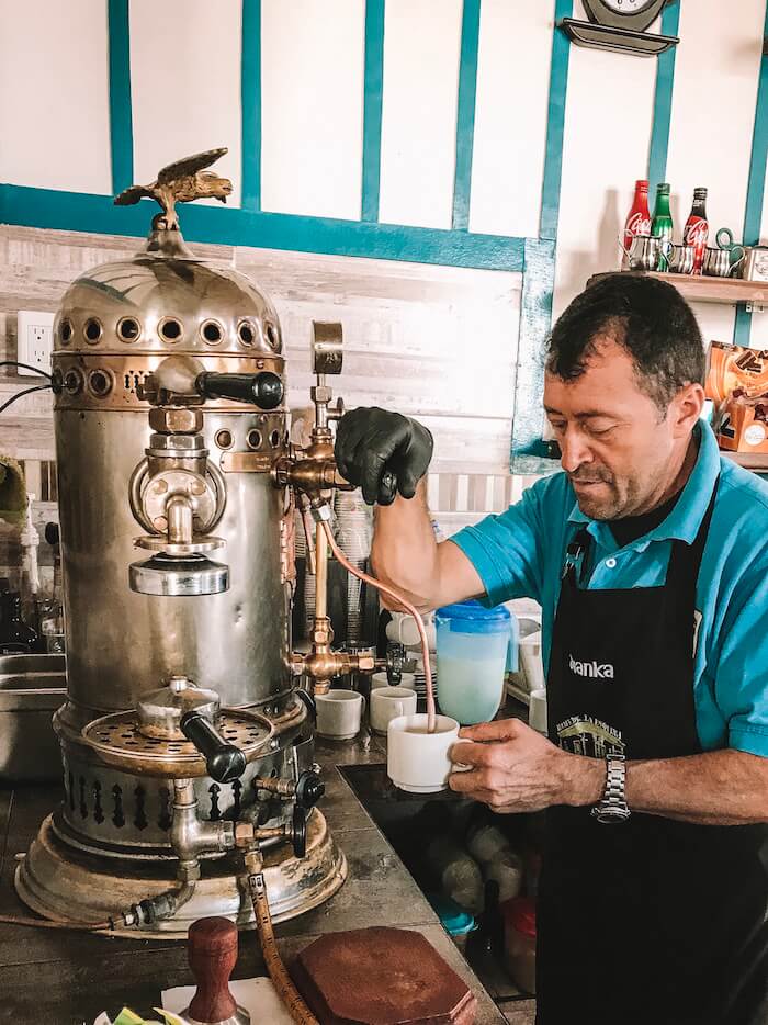 Man making coffee at Café de la Esquina in Salento Colombia
