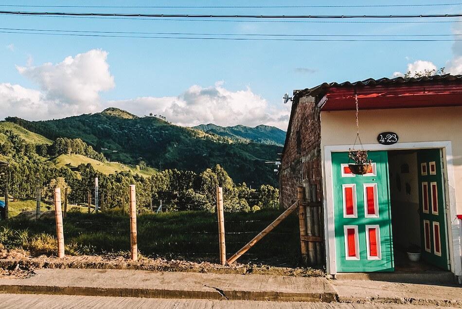 Salento Colombia | the Andes in the distance;part of an orange and green door