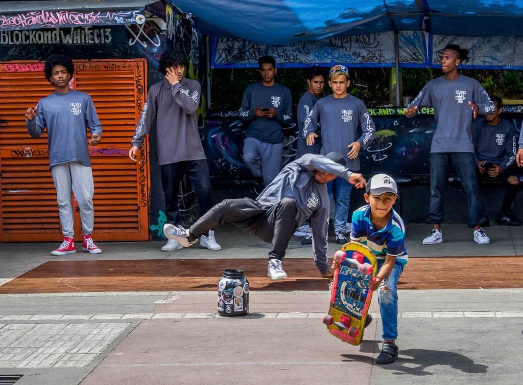 Comuna 13: a young kid with this skateboard and a breakdancer in behind