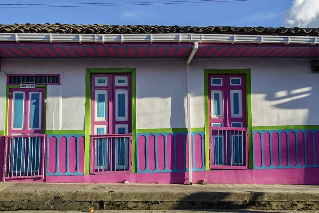Salento Colombia: pink, neon green and blue are the colours on this row of houses