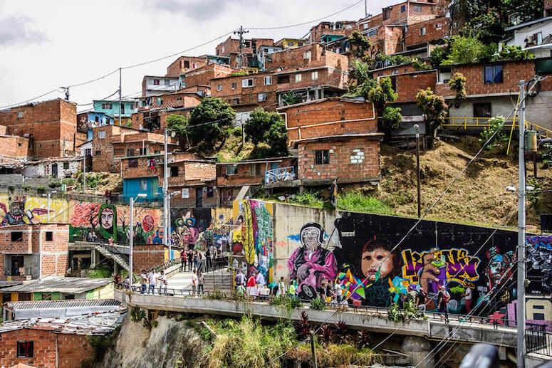 Comuna 13: the promenade with street art and above red brick houses