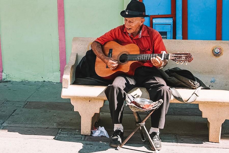 Old man with his guitar singing in Salento Colombia