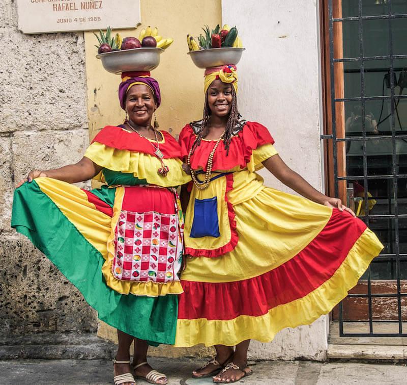 Things to do in Cartagena: Take a picture of AfroColombian ladies dressed in their colourful dresses with bowls of fruit on their head
