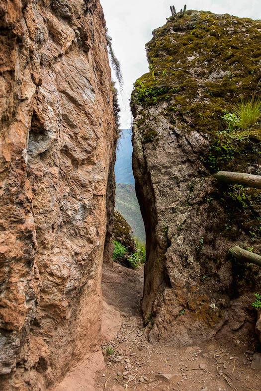a tiny path between 2 tall stones on the trail from the ruins to Pisac Peru