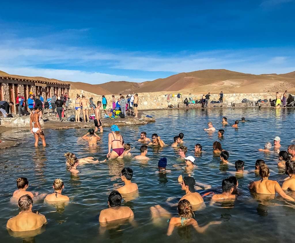people soaking in a natural hot spring in the Atacama Desert - El Tatio Geysers
