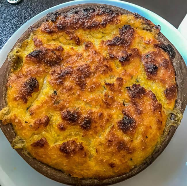 Things to do in Santiago Chile - eat this hot pie topped with a yellow corn crust