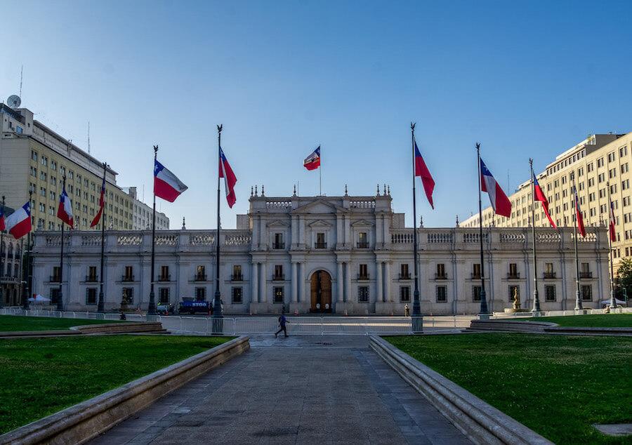 things to do in Santiago Chile -  11 Chilean flags flying in front of Palacio la Moneda