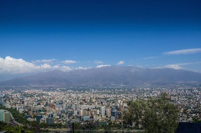 Things to do in Santiago Chile: see the view of the city with mountains in the distance and lots of blue sky