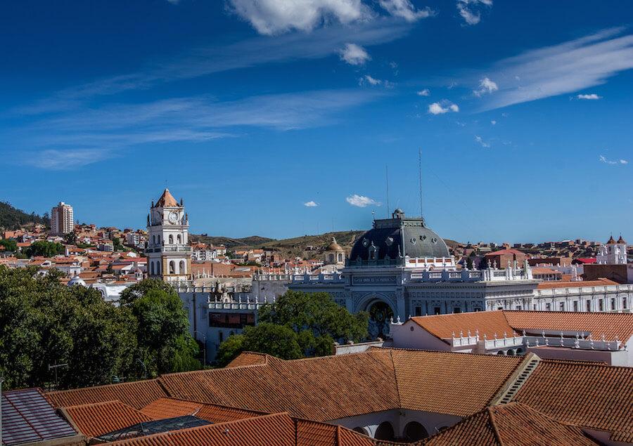 Solo Travel in South America: red tile rooftops, a white tower and big blue sky