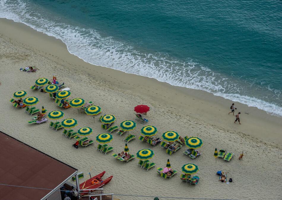 Welcome to Italy: Tropea: yellow and green beach umbrellas and the seal