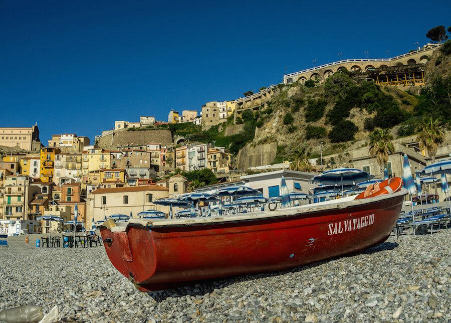 Scilla: a red fishing boat is pulled on shore