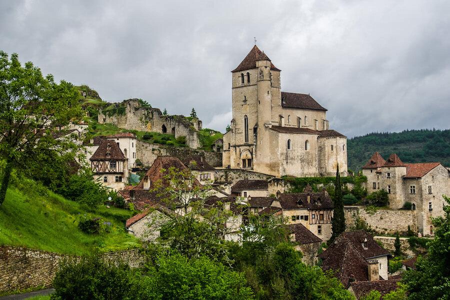 Les Plus Beaux Villages de France: the church of Saint-Cirq-Lapopie rises above the red roofs of the town 