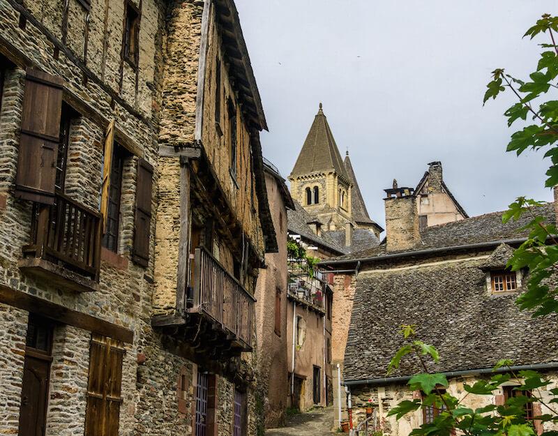 Conques France: half timbered houses and 2 of the church spires