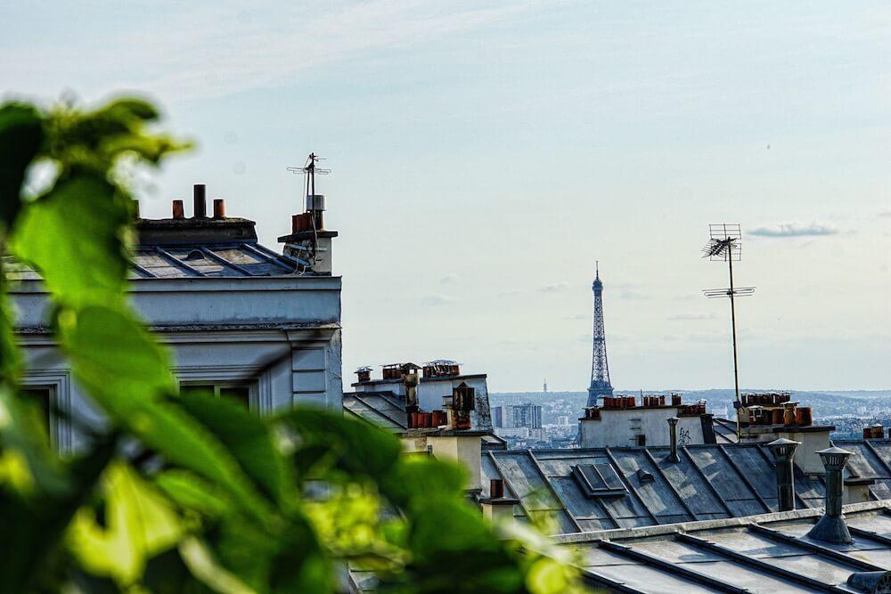 View of Paris rooftops, chimneys and the Eiffel Tower
