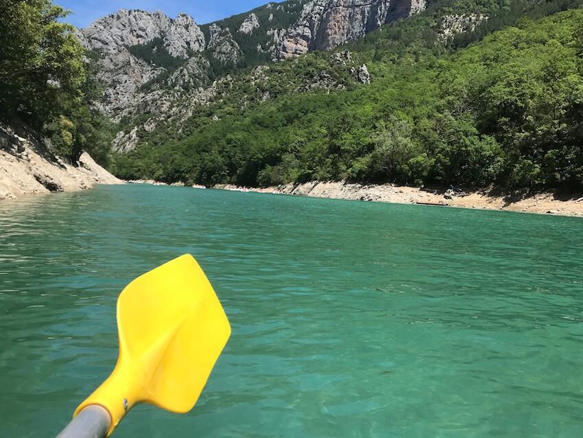 Yellow paddle against the blue waters of the Gorges du Verdon