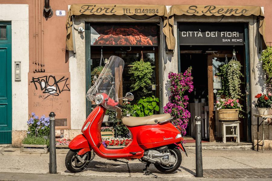 what to see in Verona- flowers and red scooters