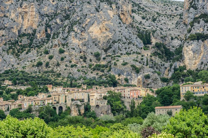Moustiers camouflaged by the imposing limestone cliffs