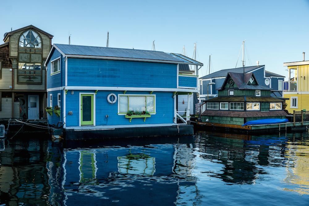 things to do in Victoria BC Canada: visit Fishermans Wharf and the houseboats. Blue houseboat and reflection