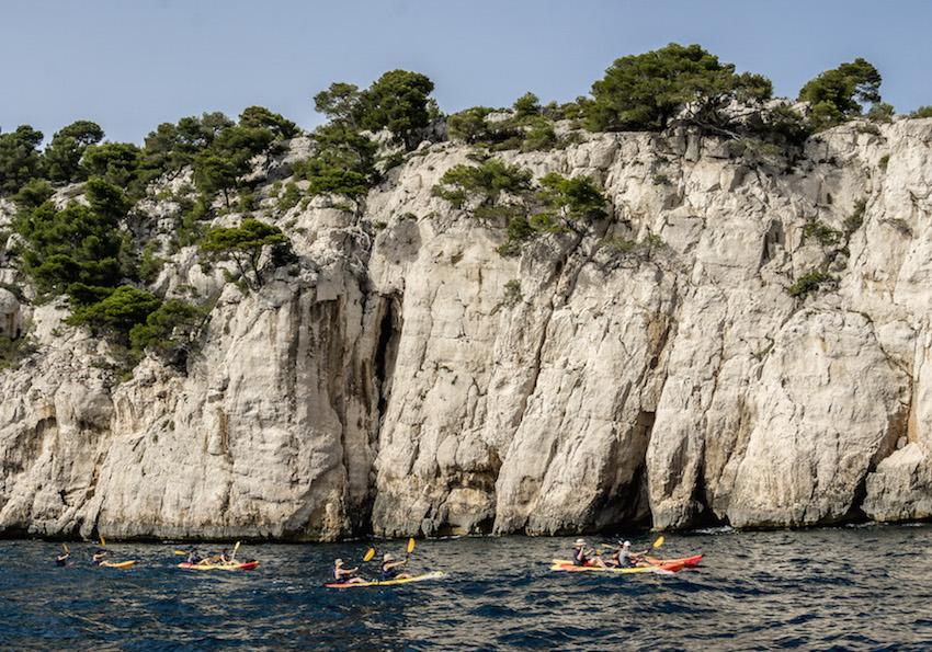 Calanques de Cassis: kayakers paddle past the white cliffs