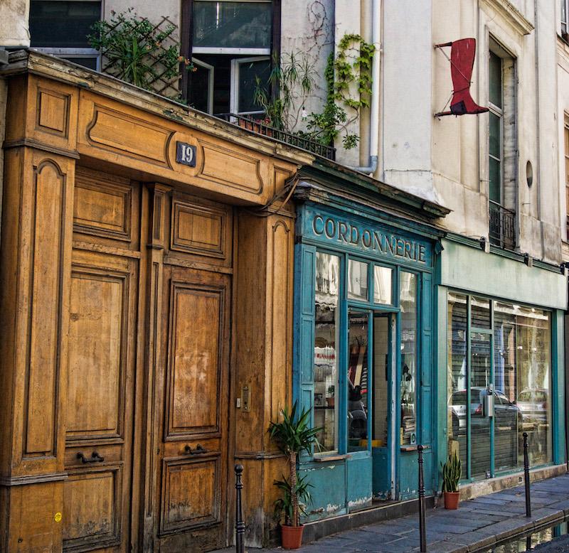 Paris Streets: la Cordonnerie -Paris blue facade red boot atop