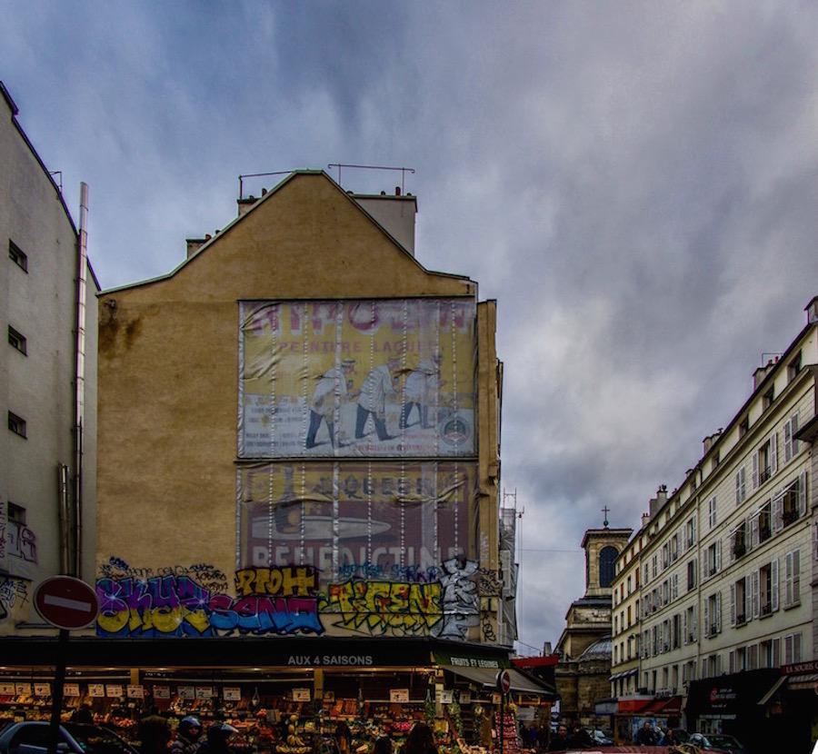 Paris streets: painting of bakers on a yellow wall of a building