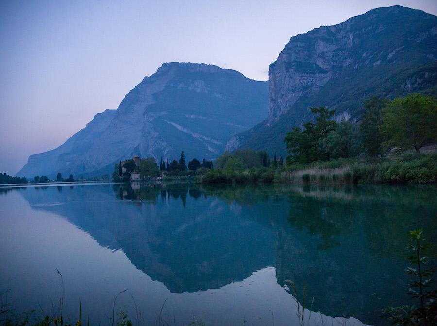 Things to do in Trento Italy: mountains reflected in the lake at evening time, blue colour, 
