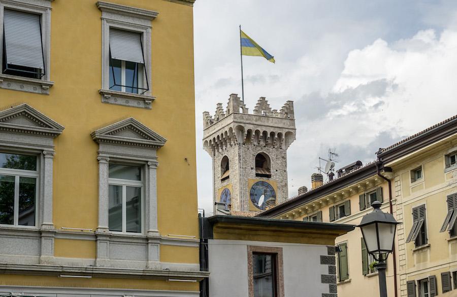 Things to do in Trento Italy: yellow buildings with a tower behind