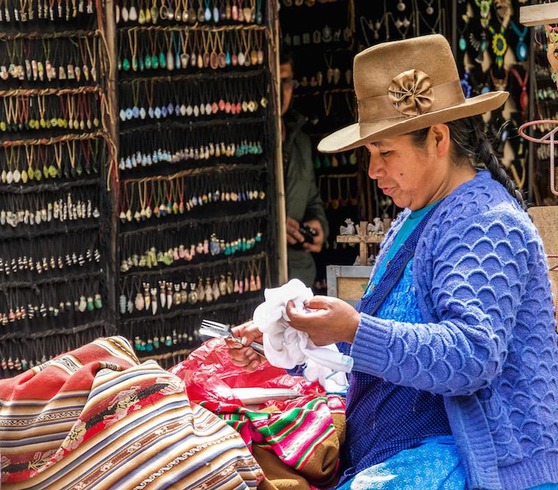 Ollantaytambo Peru:Peruvian lady wearing a beige cowboy like hat and a periwinkle blue sweater