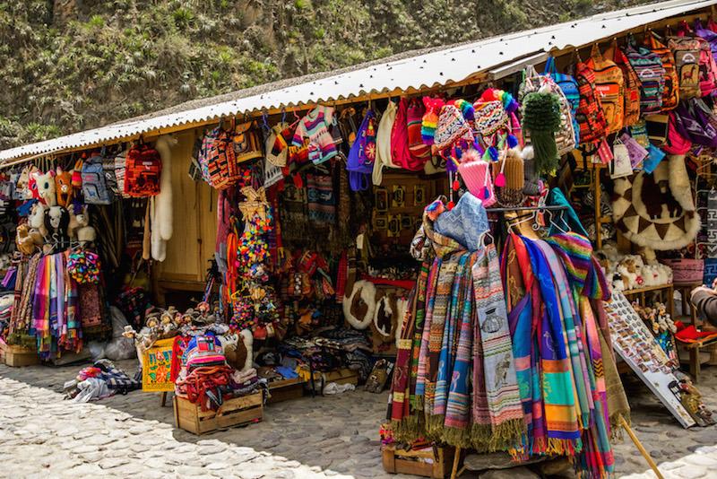Ollantaytambo Peru: market stalls full of colourful hats and scarves