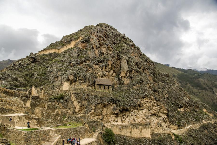 Ollantaytambo Peru: the archaeological site  with stone walls, stairs and trails backed by a huge rock mountain