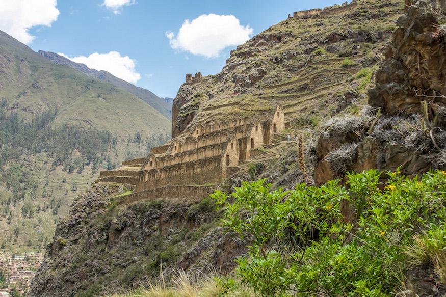 Ollantaytambo Peru: the other ruins sit on the mountainside, beige rock rectangular buildings