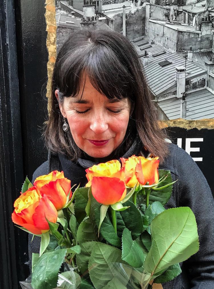 Moving to Paris, Alison Browne closes her eyes to savour the scent of these orange and yellow roses. 