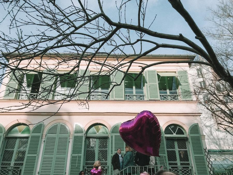 Valentine's Day in Paris at the museum with the green shutters, Musee de al vie romantique. Purple heart shaped balloon in the foreground